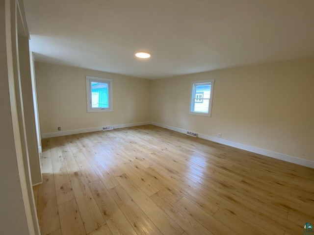 613 Vaughn Ave, Ashland, WI 54806 - unfurnished room featuring light wood finished floors, plenty of natural light, and baseboards
