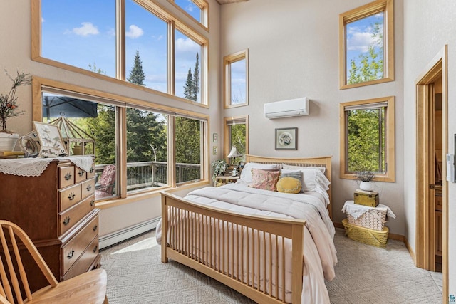 87985 Bark Point Rd, Herbster, WI 54844 - bedroom with baseboard heating, a wall unit AC, a high ceiling, and multiple windows