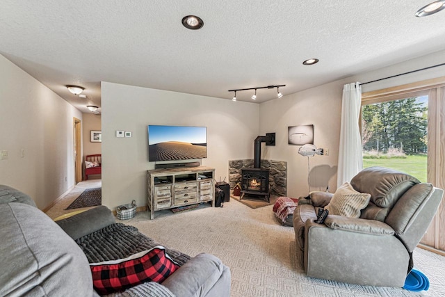 87985 Bark Point Rd, Herbster, WI 54844 - carpeted living room featuring a wood stove and a textured ceiling