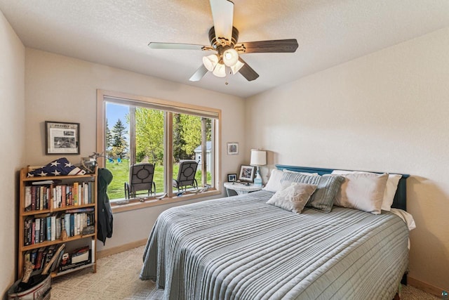 87985 Bark Point Rd, Herbster, WI 54844 - bedroom featuring light carpet, baseboards, a ceiling fan, and a textured ceiling