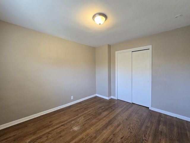 6321 W Keefe Avenue Parkway Unit 6323, Milwaukee, WI 53216 - unfurnished bedroom with dark wood-style floors, baseboards, and a closet