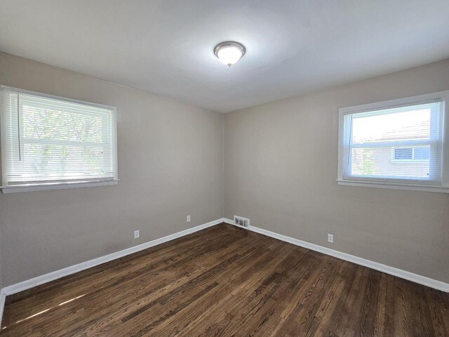 6321 W Keefe Avenue Parkway Unit 6323, Milwaukee, WI 53216 - unfurnished room featuring baseboards, plenty of natural light, and dark wood-style floors