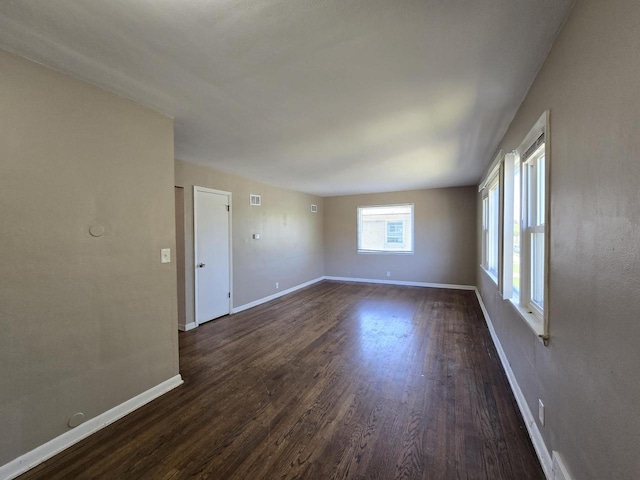 6321 W Keefe Avenue Parkway Unit 6323, Milwaukee, WI 53216 - spare room featuring dark wood-style floors and baseboards
