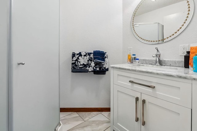 111 Rolphs Point Dr, Shell Lake, WI 54871 - bathroom featuring marble finish floors, vanity, and baseboards