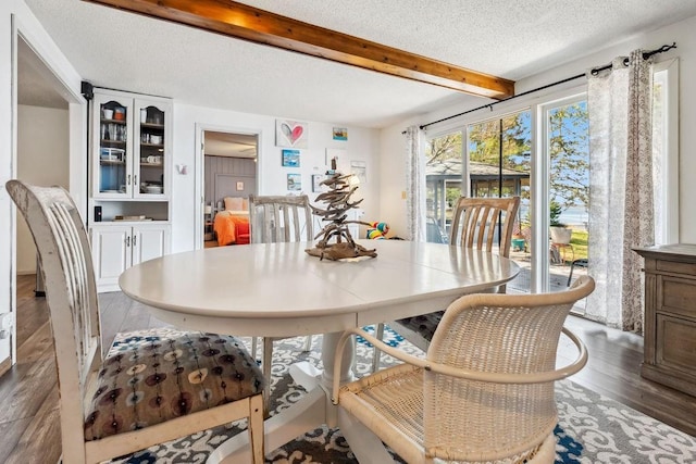 111 Rolphs Point Dr, Shell Lake, WI 54871 - dining area with wood finished floors, beamed ceiling, and a textured ceiling