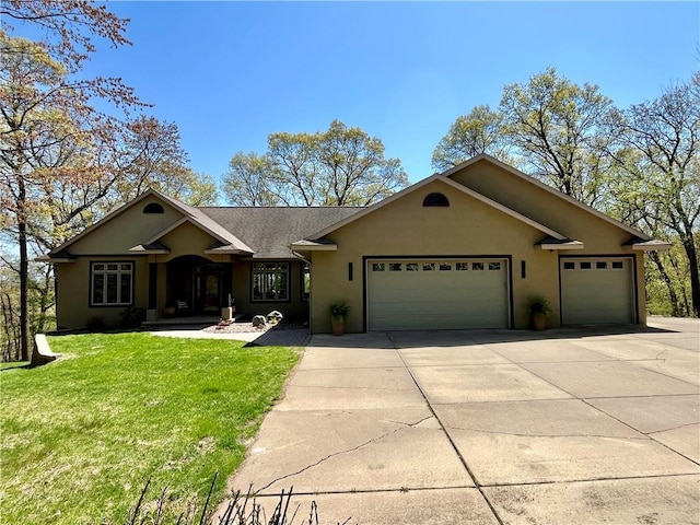 4221 Lassek Ct, Eau Claire, WI 54703 - single story home featuring a garage, driveway, a front lawn, and stucco siding
