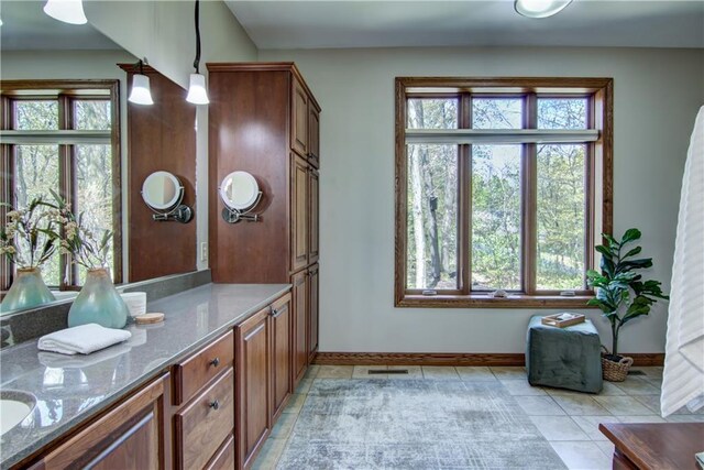 4221 Lassek Ct, Eau Claire, WI 54703 - bathroom featuring baseboards, tile patterned flooring, plenty of natural light, and vanity