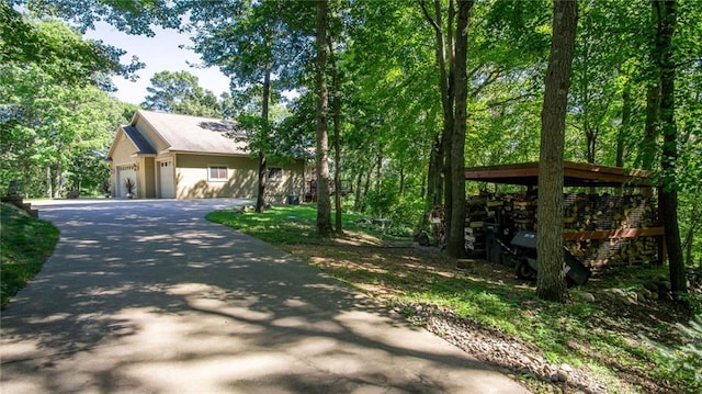 4221 Lassek Ct, Eau Claire, WI 54703 - view of side of property featuring asphalt driveway and an attached garage