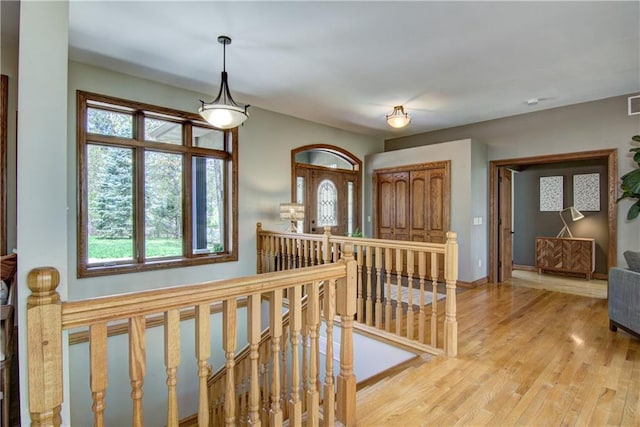 4221 Lassek Ct, Eau Claire, WI 54703 - hall featuring an upstairs landing, wood finished floors, and baseboards