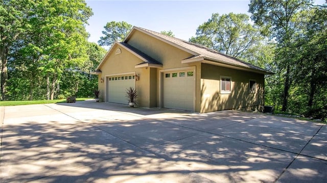 4221 Lassek Ct, Eau Claire, WI 54703 - view of home's exterior with stucco siding and concrete driveway