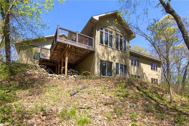 4221 Lassek Ct, Eau Claire, WI 54703 - rear view of house with a wooden deck and stucco siding