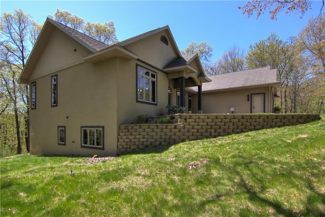 4221 Lassek Ct, Eau Claire, WI 54703 - view of side of property with stucco siding and a yard