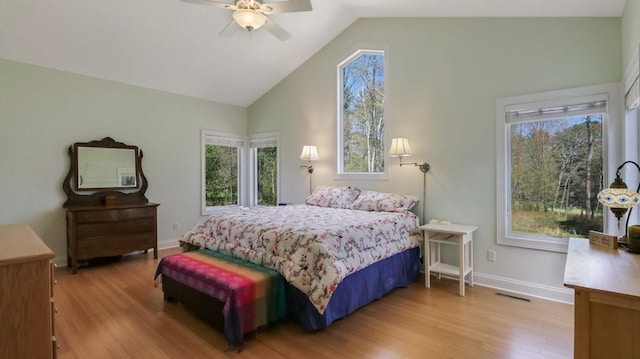 12384 98th St, Chippewa Falls, WI 54729 - bedroom featuring wood finished floors, multiple windows, high vaulted ceiling, baseboards, and a ceiling fan