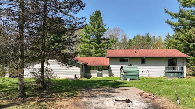 9027 W County Road D, Holcombe, WI 54745 - back of property featuring a lawn and a sunroom