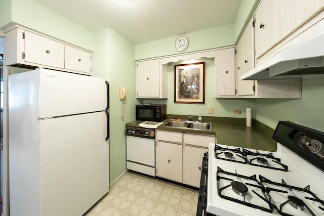 205 Country Club Dr Unit 3D, Lake Geneva, WI 53147 - kitchen featuring white appliances, under cabinet range hood, a sink, dark countertops, and light floors