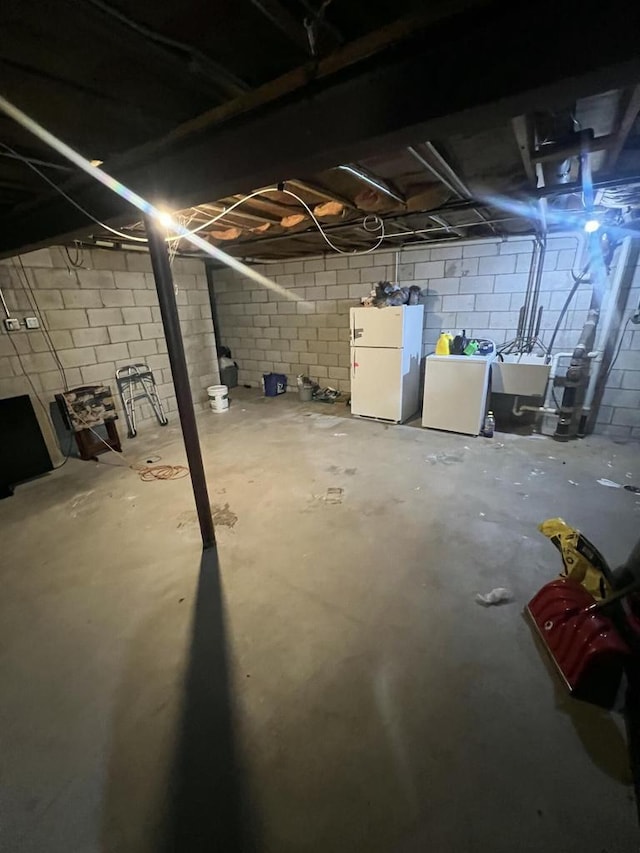 8657 N 73rd St, Milwaukee, WI 53223 - unfinished basement with freestanding refrigerator, separate washer and dryer, and a sink