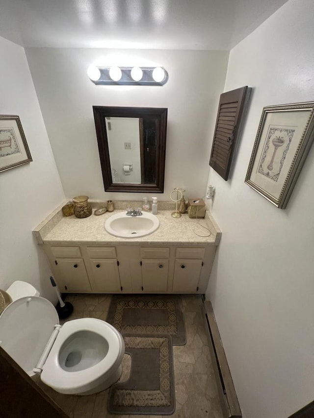 8657 N 73rd St, Milwaukee, WI 53223 - bathroom with vanity, a baseboard heating unit, and toilet