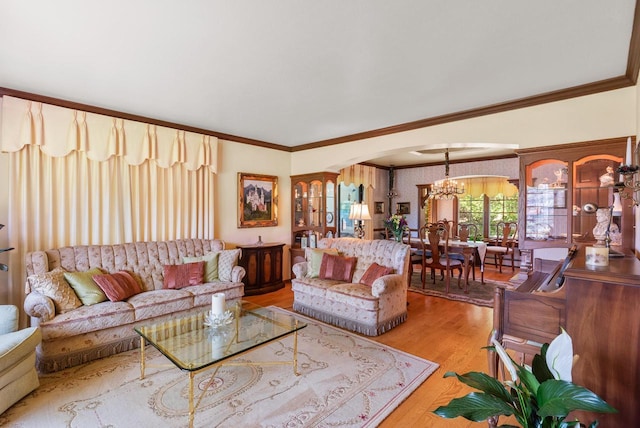 4151 Elmwood Rd, Colgate, WI 53017 - living area with arched walkways, a chandelier, wood finished floors, and crown molding