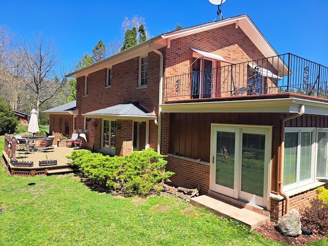4151 Elmwood Rd, Colgate, WI 53017 - back of property with a balcony, brick siding, and a lawn