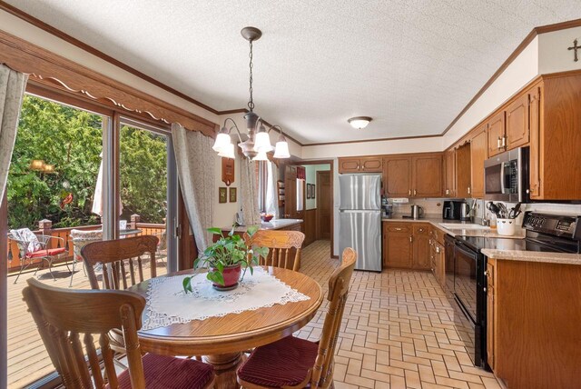 4151 Elmwood Rd, Colgate, WI 53017 - kitchen with stainless steel appliances, ornamental molding, a chandelier, light countertops, and brick patterned floors