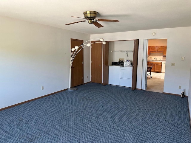 empty room featuring washing machine and clothes dryer, ceiling fan, carpet, and baseboards