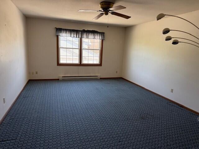 carpeted empty room featuring a baseboard radiator, ceiling fan, and baseboards