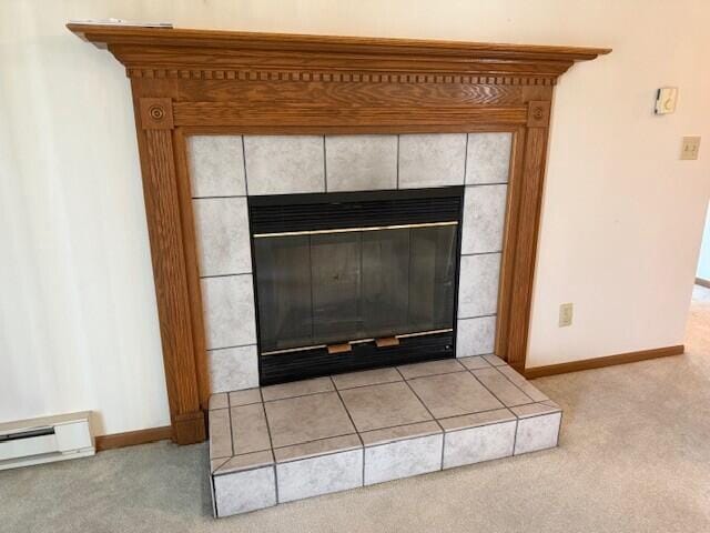 detailed view of carpet floors, a tiled fireplace, baseboards, and a baseboard radiator