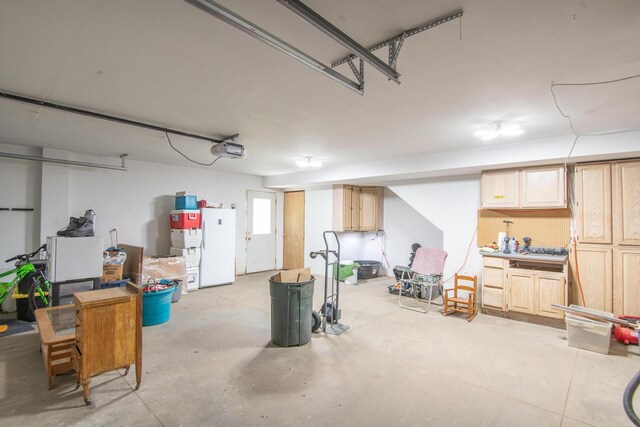552 11th St, Kenosha, WI 53140 - garage featuring a garage door opener and freestanding refrigerator