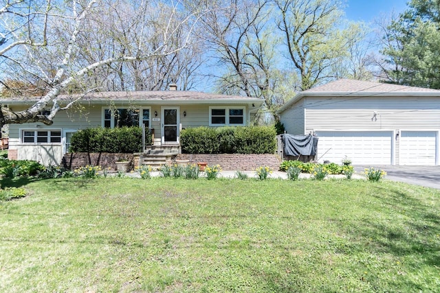 552 11th St, Kenosha, WI 53140 - view of front facade featuring a front yard, driveway, and a chimney