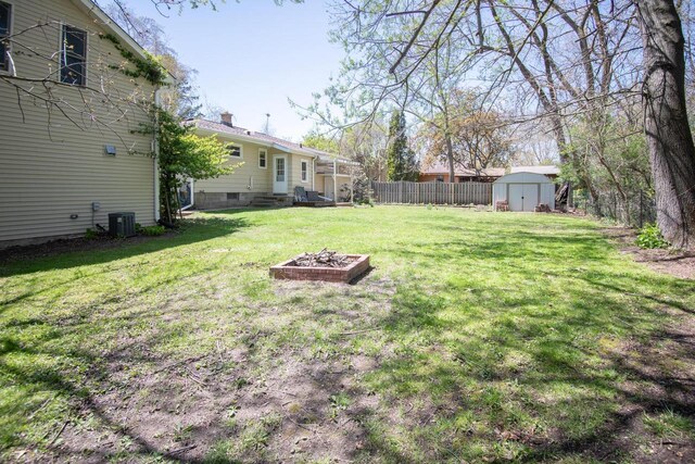 552 11th St, Kenosha, WI 53140 - view of yard featuring a storage unit, cooling unit, an outdoor structure, and entry steps