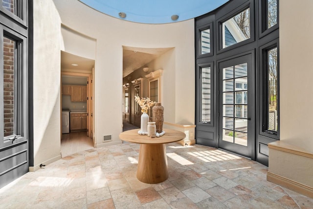 889 Horns Corners Rd, Cedarburg, WI 53012 - foyer entrance with stone tile flooring, a towering ceiling, and baseboards