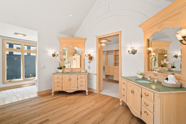 889 Horns Corners Rd, Cedarburg, WI 53012 - bathroom featuring lofted ceiling, wood finished floors, and two vanities