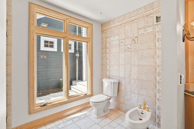 889 Horns Corners Rd, Cedarburg, WI 53012 - half bathroom with tile walls, a bidet, toilet, and tile patterned floors