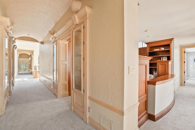 889 Horns Corners Rd, Cedarburg, WI 53012 - corridor featuring light colored carpet, lofted ceiling, arched walkways, built in features, and a textured wall