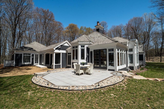 889 Horns Corners Rd, Cedarburg, WI 53012 - rear view of property featuring a sunroom, a chimney, a patio area, and a lawn
