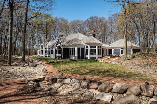 889 Horns Corners Rd, Cedarburg, WI 53012 - back of house with a sunroom, a chimney, and a lawn