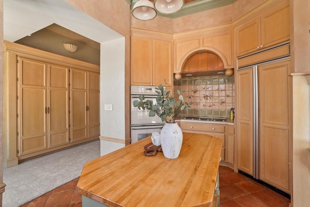889 Horns Corners Rd, Cedarburg, WI 53012 - kitchen with white double oven, dark tile patterned flooring, cooktop, paneled fridge, and butcher block countertops