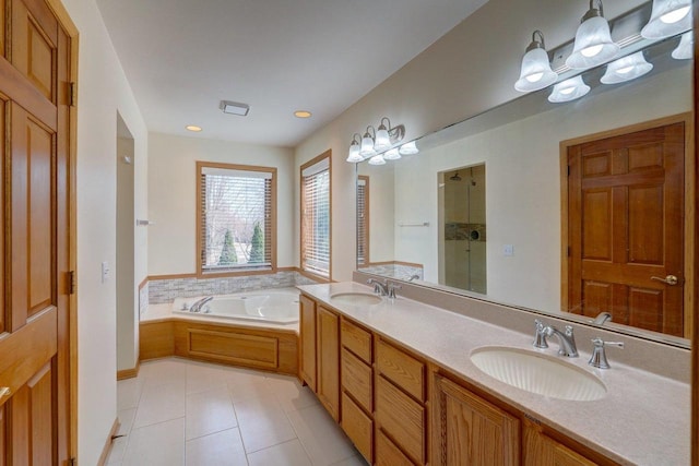 821 Ondossagon Way, Madison, WI 53719 - full bath with tile patterned flooring, a stall shower, a garden tub, double vanity, and recessed lighting