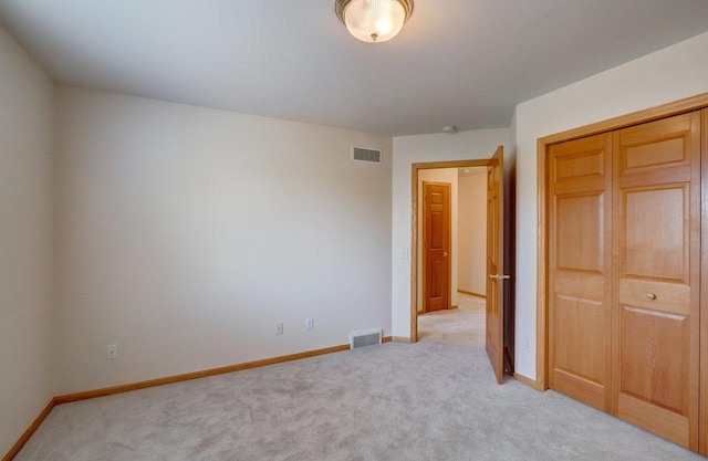 821 Ondossagon Way, Madison, WI 53719 - unfurnished bedroom featuring light carpet, baseboards, and a closet