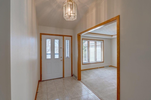 821 Ondossagon Way, Madison, WI 53719 - foyer featuring baseboards, light colored carpet, a chandelier, light tile patterned flooring, and lofted ceiling