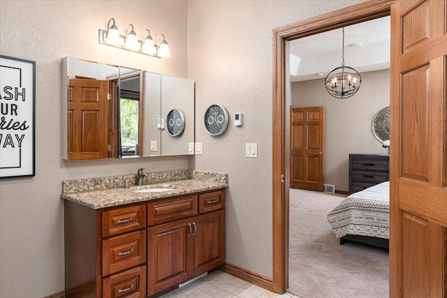 403 14th St, North Street, La Crescent, MN 55947 - bathroom featuring a textured wall, a chandelier, baseboards, and vanity