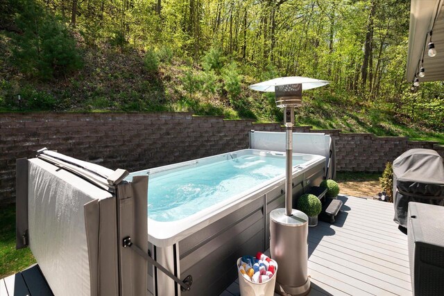 403 14th St, North Street, La Crescent, MN 55947 - wooden deck featuring a hot tub, a view of trees, and area for grilling