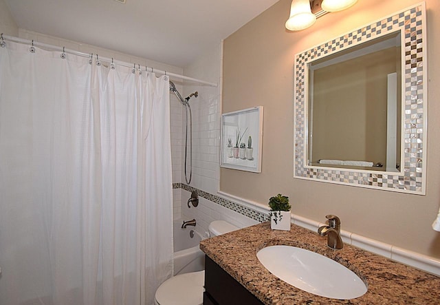 full bathroom with toilet, vanity, and shower / tub combo