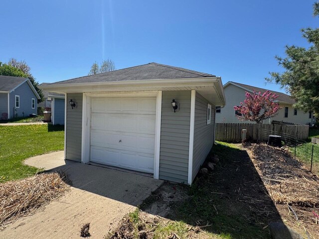 4814 Freese Ln, Madison, WI 53718 - detached garage featuring fence, driveway, and central air condition unit