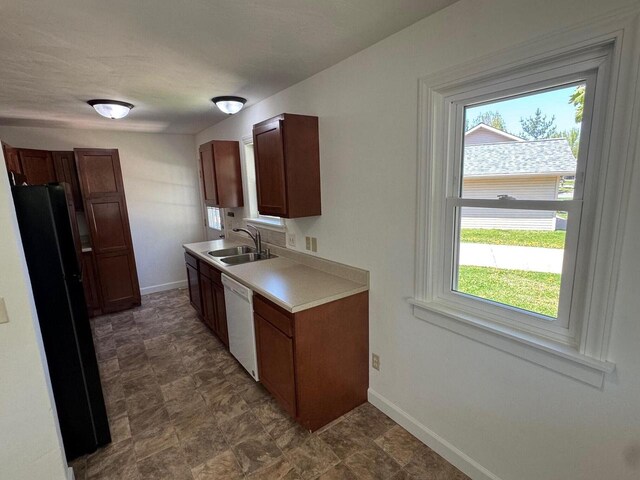 4814 Freese Ln, Madison, WI 53718 - kitchen featuring a sink, freestanding refrigerator, white dishwasher, and healthy amount of natural light