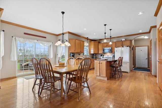 2583 Countryside Ln, Richfield, WI 53076 - dining area with ornamental molding, light wood-style flooring, healthy amount of natural light, baseboards, and a chandelier