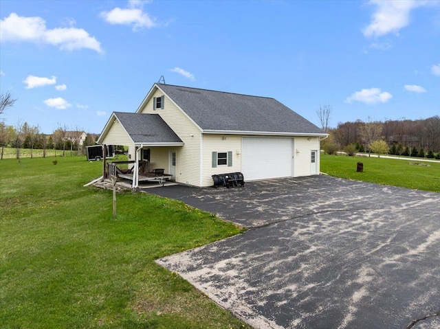 2583 Countryside Ln, Richfield, WI 53076 - view of home's exterior featuring a lawn, asphalt driveway, and roof with shingles