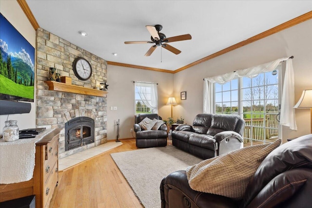 2583 Countryside Ln, Richfield, WI 53076 - living area featuring ceiling fan, crown molding, wood finished floors, a stone fireplace, and baseboards