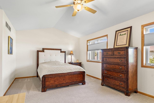 bedroom featuring multiple windows, vaulted ceiling, light carpet, baseboards, and ceiling fan