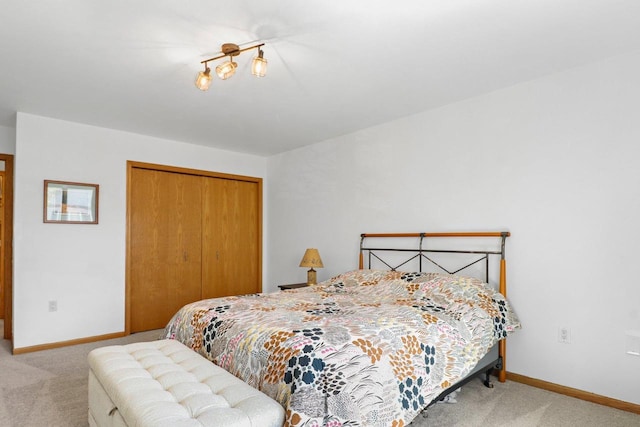 bedroom featuring carpet floors, a closet, and baseboards